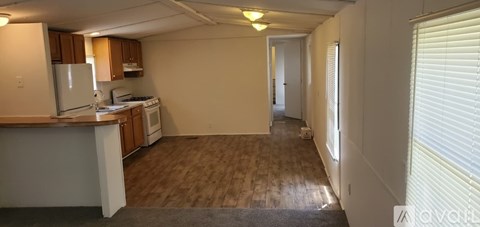 A kitchen with wooden cabinets and a white stove top oven.