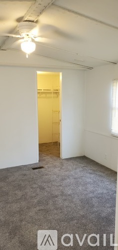 A white door is on a metal building with a concrete step leading up to it.