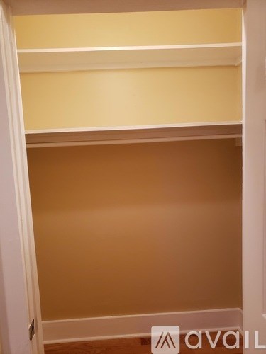 A white door with a brown wall behind it.