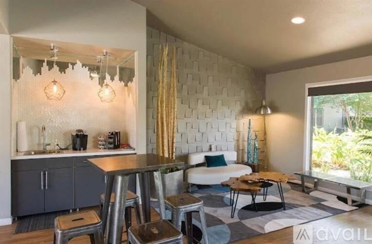 A modern kitchen with a breakfast bar and a dining table.