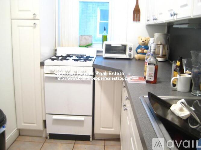A kitchen with a stove top oven and a microwave.