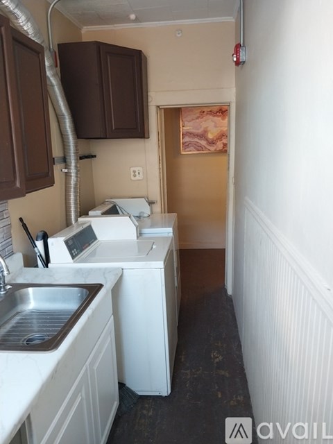 A small kitchen with a sink, stove, and dishwasher.