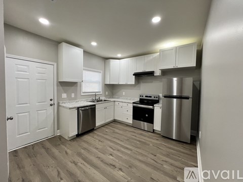 A kitchen with white cabinets and stainless steel appliances.