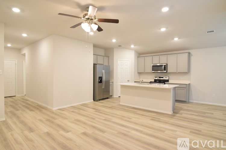 A spacious kitchen with a refrigerator, microwave, and oven.