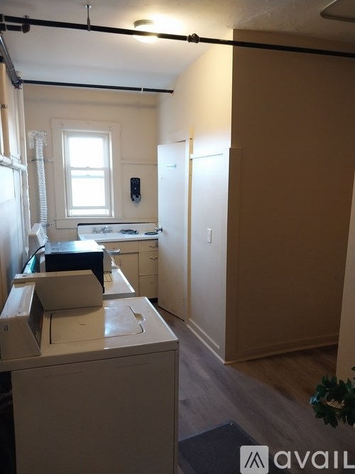 A room with a washing machine and a window.