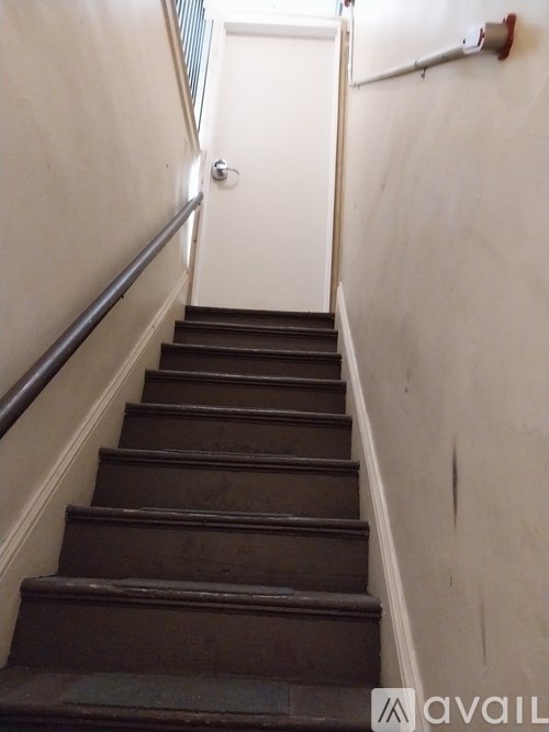 A set of stairs leading to a white door.