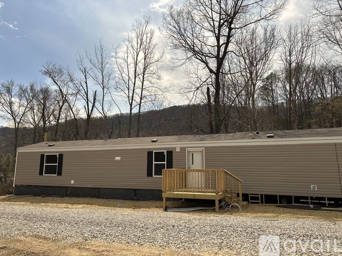 A mobile home with a deck in front of it.