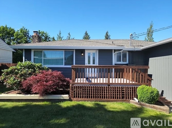 A house with a grey roof and a wooden deck.