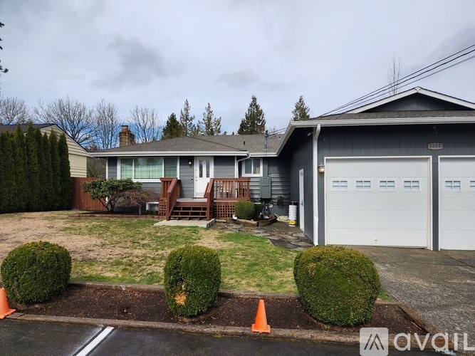 A house with a grey roof and a white garage door.