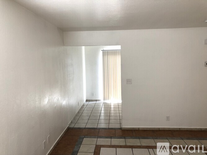 A room with a tiled floor and a window.