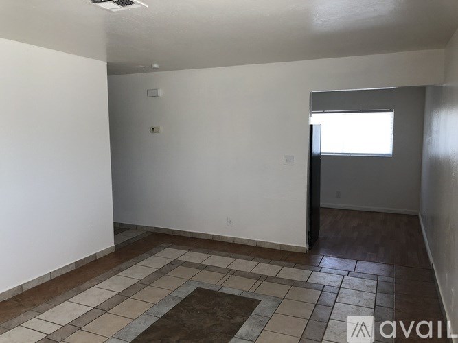 A room with a tiled floor and a window.