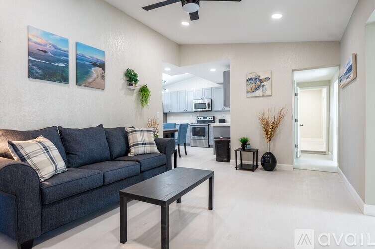 A living room with a grey couch and a coffee table.