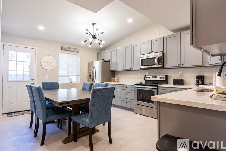A kitchen with a table and chairs in the middle of it.