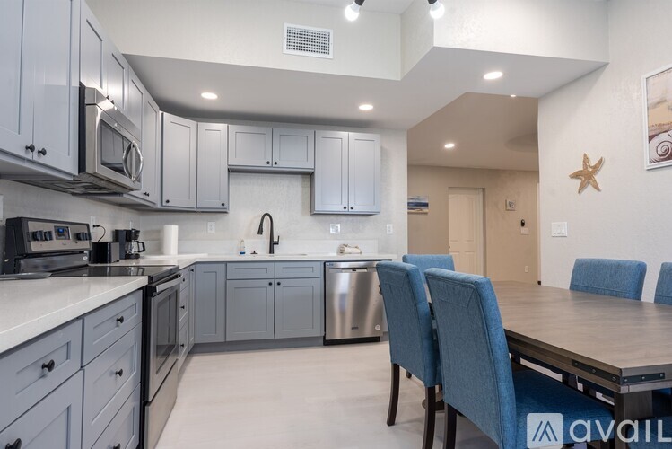A kitchen with a table and chairs.