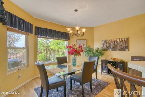A dining room with a glass table and chairs.