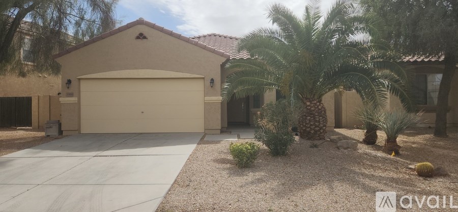 A house with a garage and a driveway in front of it.