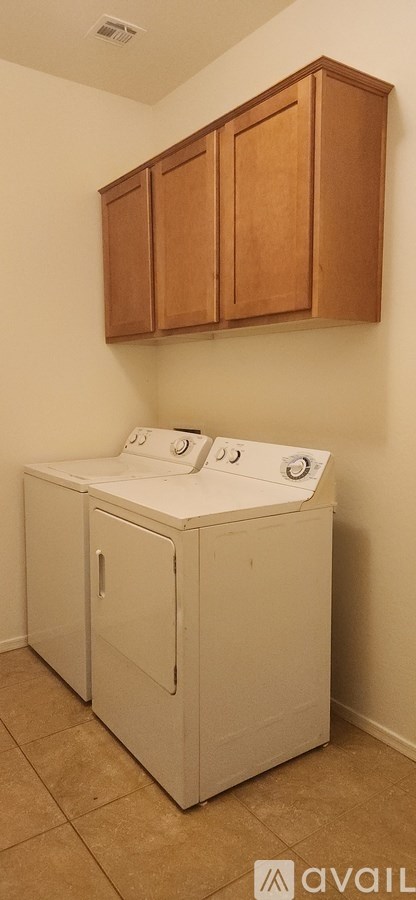 A white washer and dryer in a laundry room.