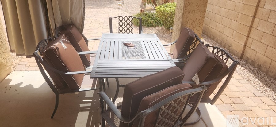 A table with chairs is set up outside.