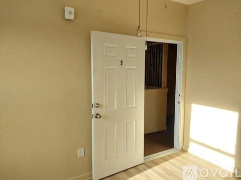 A white door with a number 9 on it is open.