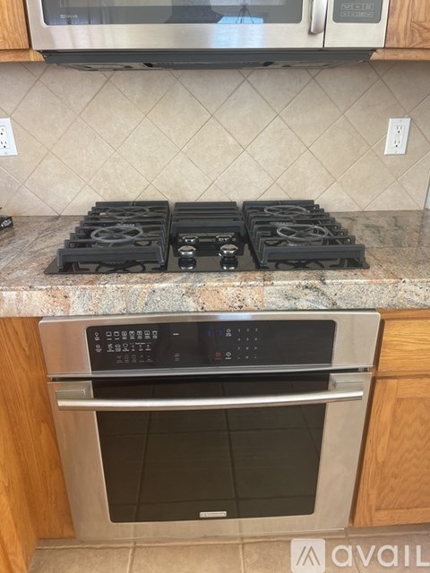 A modern kitchen with a stove top and an oven.