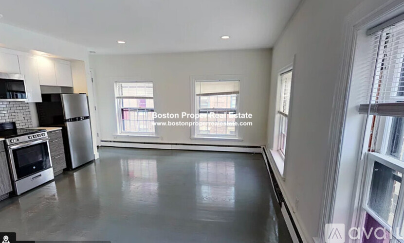 A spacious kitchen with stainless steel appliances and a large island.