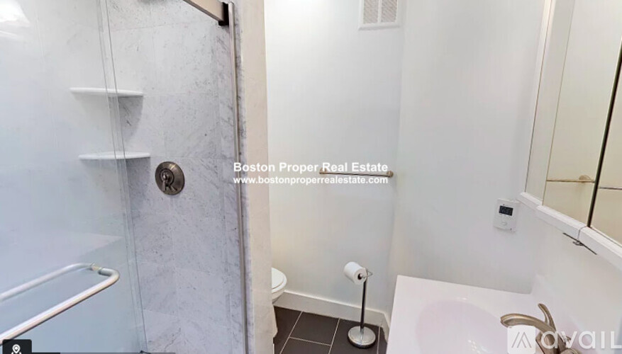 A bathroom with a walk-in shower and a toilet.