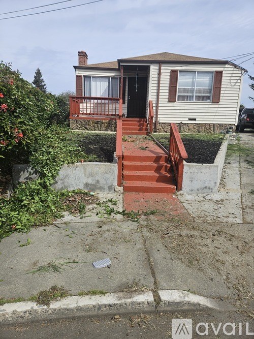 A house with a red staircase leading to the front door.
