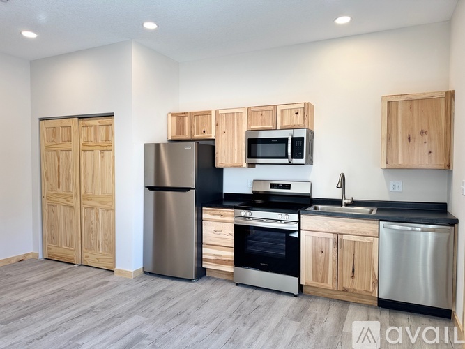 A kitchen with wooden cabinets and stainless steel appliances.