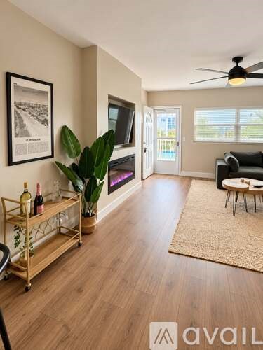 A kitchen with white cabinets and a wooden floor.