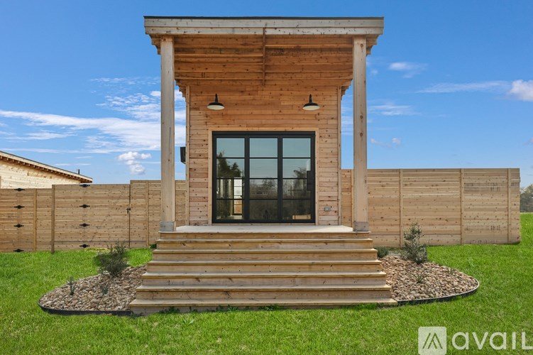 A wooden house with a glass door and windows.