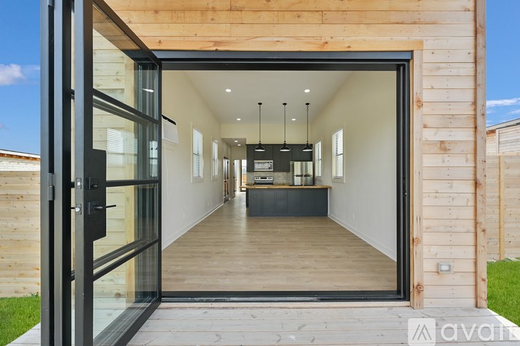 A modern house with a wooden exterior and a glass door entrance.