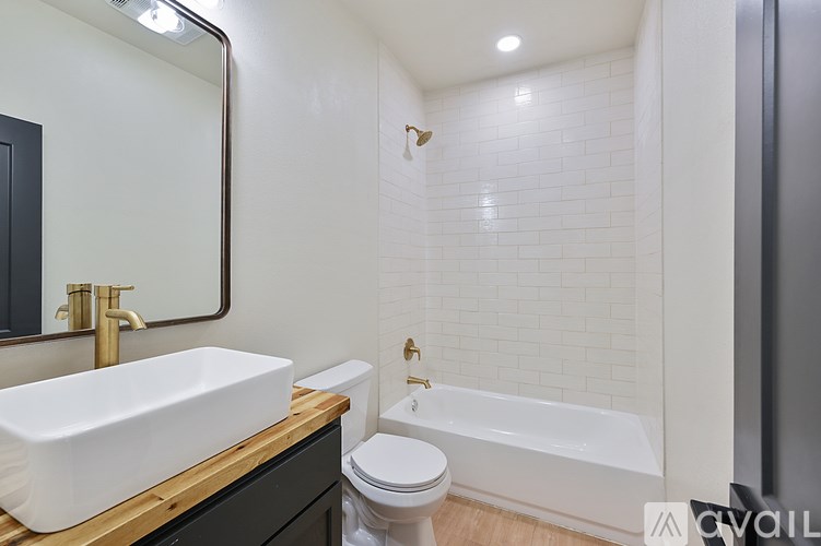 A bathroom with a white sink and a white toilet.