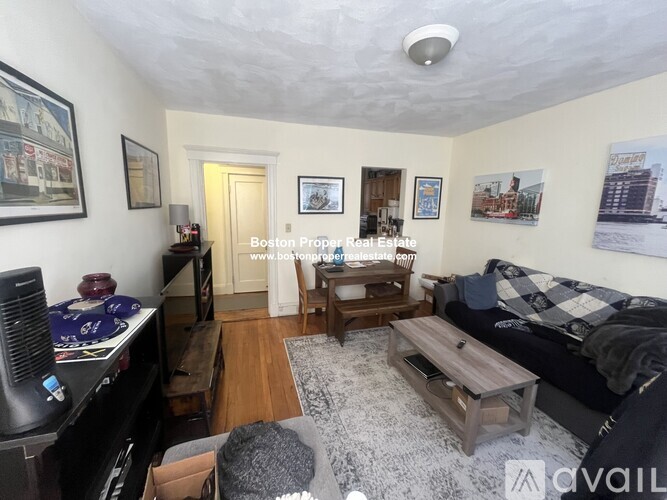 A living room with a couch, coffee table, and television.