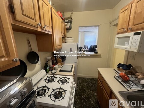 A kitchen with a stove top oven and a microwave.