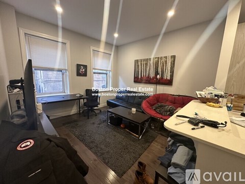 A living room with a red couch and a television.