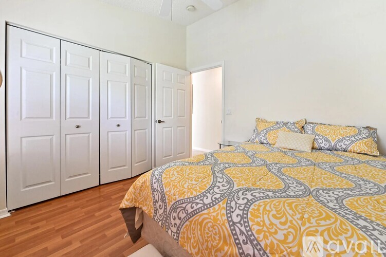 A bedroom with a bed and a wardrobe.