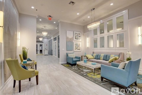 A living room with a yellow chair and a blue couch.