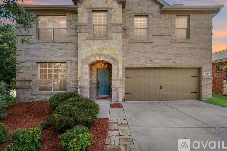 A house with a stone facade and a green door is available for sale.