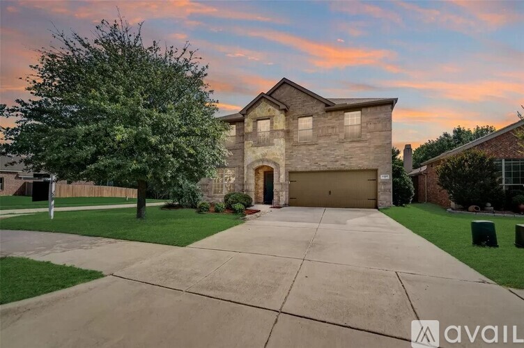 A house with a driveway and a garage is available for sale.