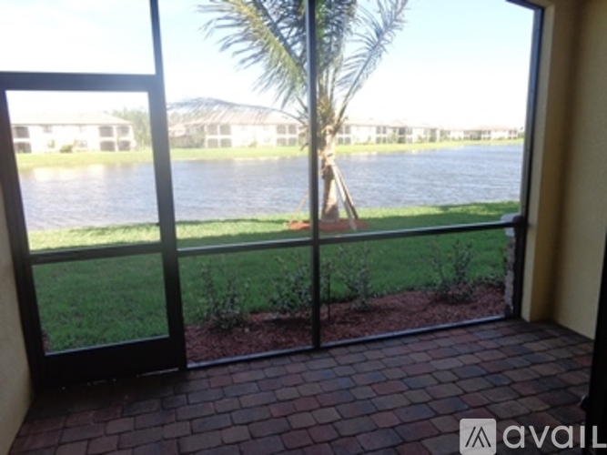 A view of a lake through a sliding glass door.