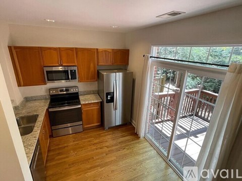 A kitchen with wooden cabinets and stainless steel appliances.