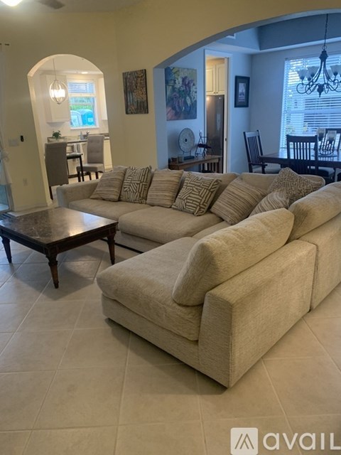 A living room with a large sectional sofa and a coffee table.