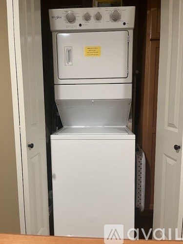 A white dishwasher and oven combo is available for rent.
