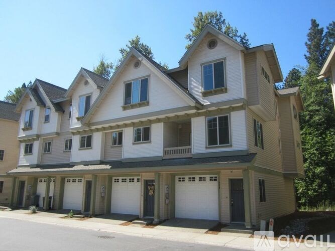A row of houses with garages on the ground floor.