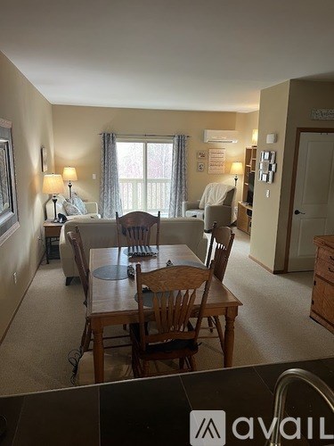 A dining room with a table and chairs is shown.