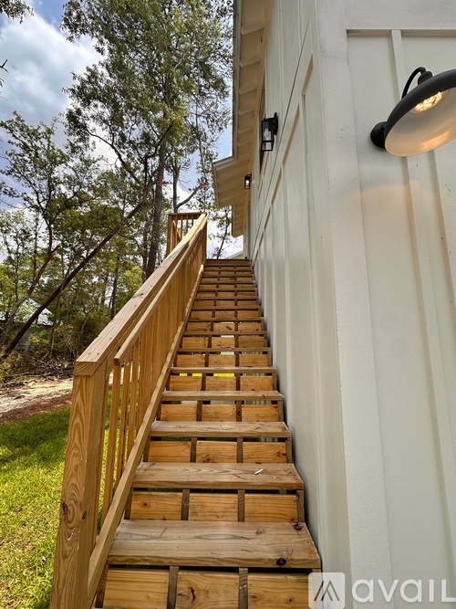 A wooden staircase leading up to a white building.