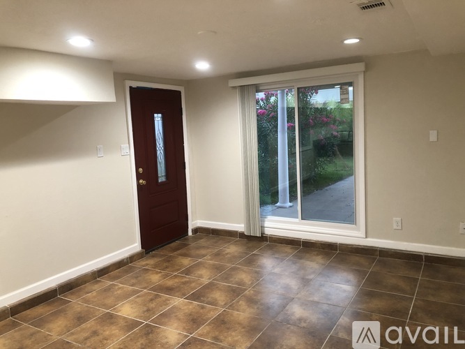 A room with a brown tile floor and a brown door.