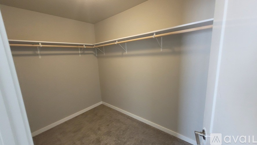 Empty room with a shelf and a door.