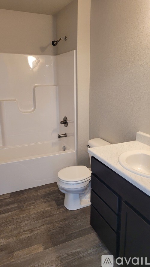 A bathroom with a toilet, sink, and bathtub.