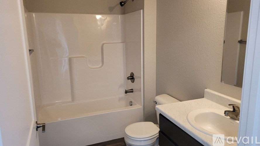 A bathroom with a toilet, sink, and bathtub.